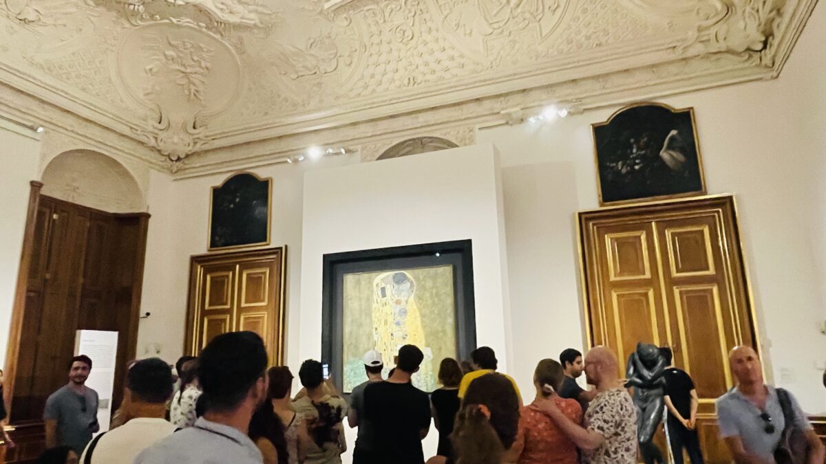 ベルヴェデーレ宮殿上宮美術館に展示されているクリムトの「接吻」を見ている人たち